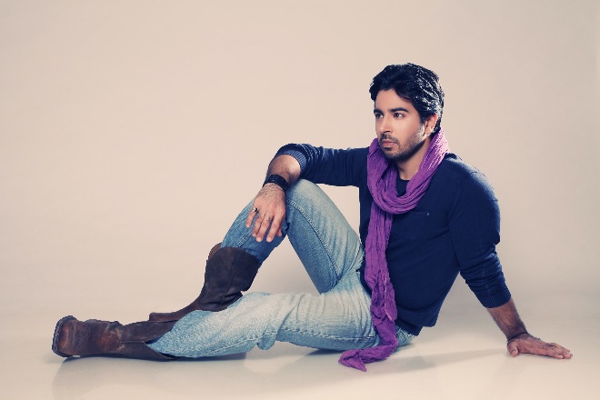 Banishu, musician, composer and independent artist, sitting at the floor